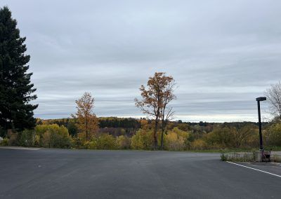 View across parking lot from front of building look at view of fall trees in Crystal Falls, MI.