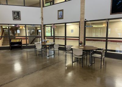 Circle tables with chairs in open common area in nice apartment building in Iron County Upper Peninsula of Michigan.