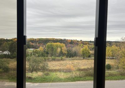 View of fall trees out 2nd floor windows of Iron County Housing Commission building in Crystal Falls, MI.
