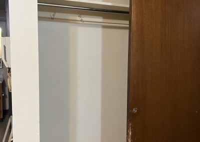 Open closet with sliding door in affordable housing in Upper Peninsula of Michigan.