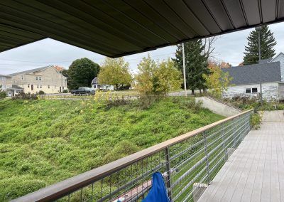 Back entrance of apartment building with path and stairs to road in Iron County Michigan.